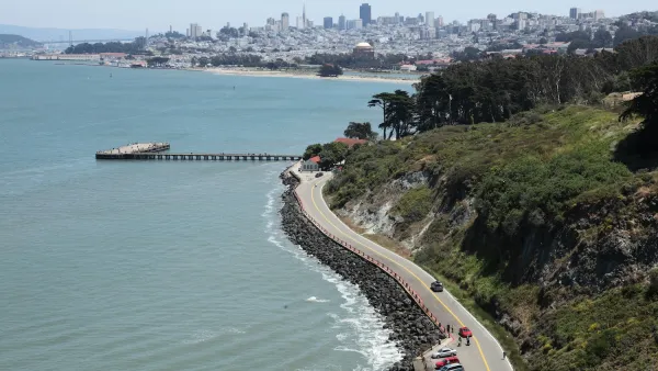 Aerial of paved road on San Francisco coastline.