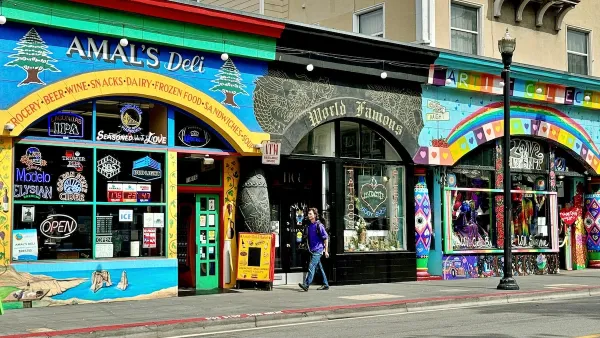 Street view of Amal’s Deli, World Famous Tattoo, and Love on Haight storefronts decorated with bright murals and rainbow-colored psychedelic designs.