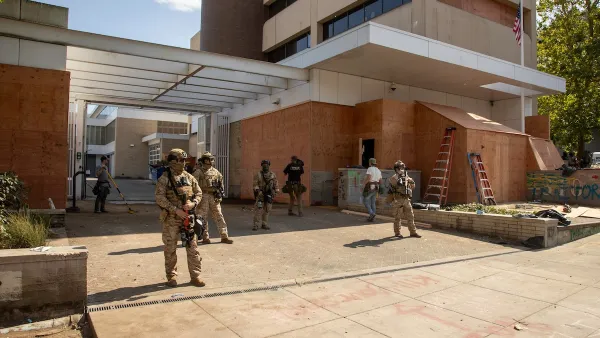 Armed military personnel guarding ICE builing in downtown Portland, Oregon.
