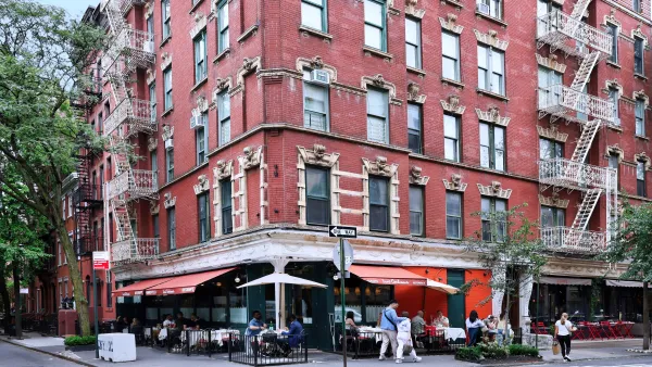 Old apartment building with restaurants on ground floor in NYC.