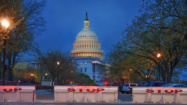 US Capitol dome in Washingotn DC at night with chain link fence set up to prevent trespassing.