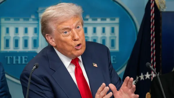 Trump gestured behind a podium. His hands are held close together.