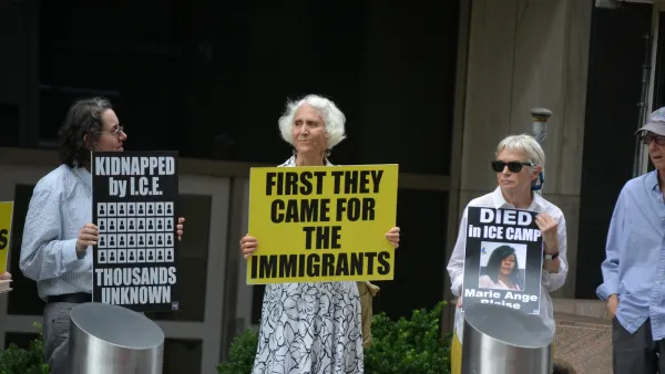 Three older women hold up signs protesting deportation and ICE abuses in New York City.