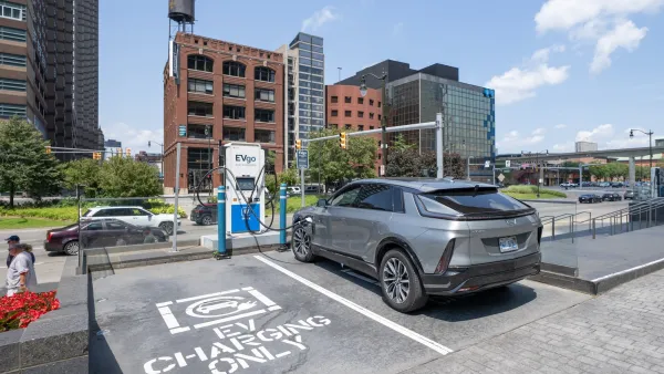 Silver SUV parked at outdoor EV charging station in Detroit, Michigan.