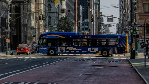 Bus passing across Madison Avenue in New York City.