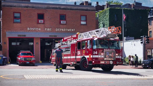 Boston FD fire station with red fire truck halfway out of the door.