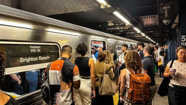 A crowd of people try to get on a NYC subway.