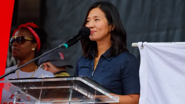 Boston Mayor Michelle Wu stands at lectern during speech.