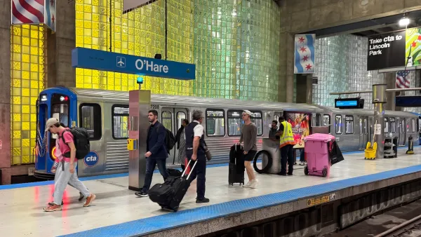Busy train platform for subterranean Chicago O'Hare airport station.