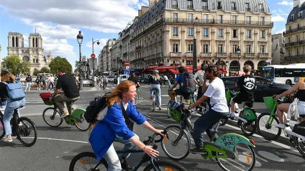 people riding bikes in street in Paris, France.