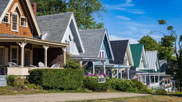 Single-story colorful wood houses with strongly pitched roofs in Maine.