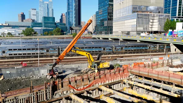 Large orange crane at construction site for Gateway Project tunnel.