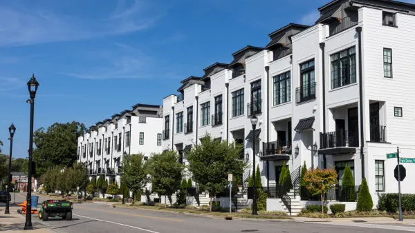 White three-story apartment building in Durham, North Carolina.