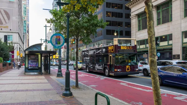 Red bus lane on busy street in Philadelphia, Pennsylvania.