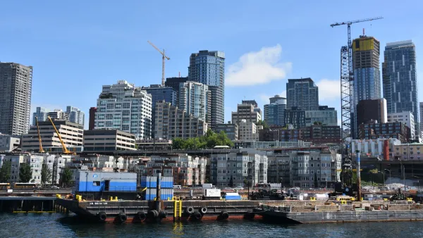 Downtown Seattle as seen from water with construction cranes visible.