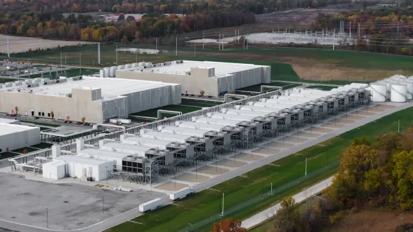A data center. It is a low, white building, seen from above.
