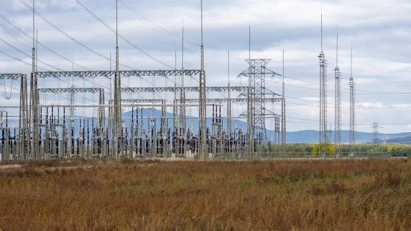 Cluster of power poles and lines in a flat, rural area.