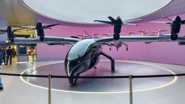 One of Archer Aviations air taxis. it has four small propellers and a sleek black build.