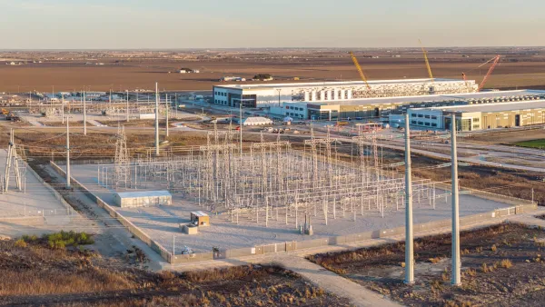 Aerial of large data center with power substation at golden hour.