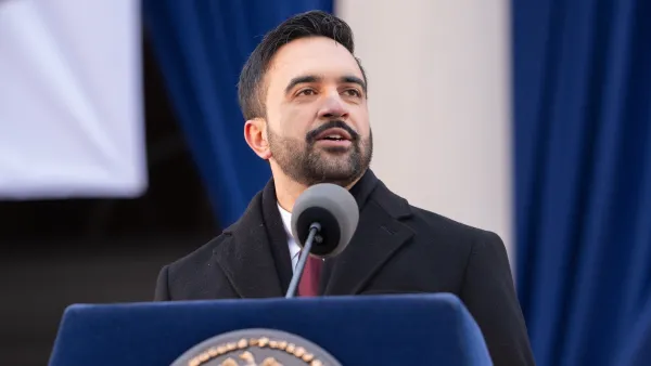 NYC Mayor Zohran Mandami speaks behind a blue podium.