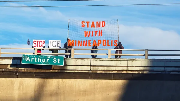  Protesters stand on top of a freeway overpass over the I-90 freeway with a Stand With Minneapolis banner as a result of the ICE shooting in Minnesota. 