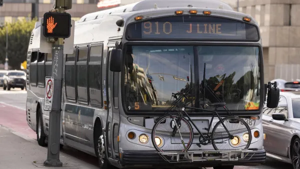 Silver Los Angeles Metro transit bus with bike mounted infront rack.