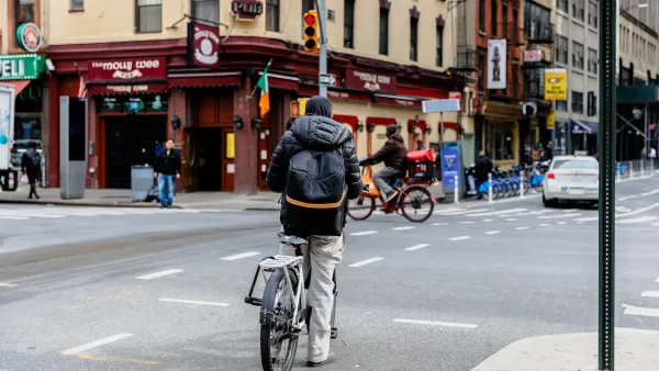 Man on e-bike in New York City on a cloudy day.