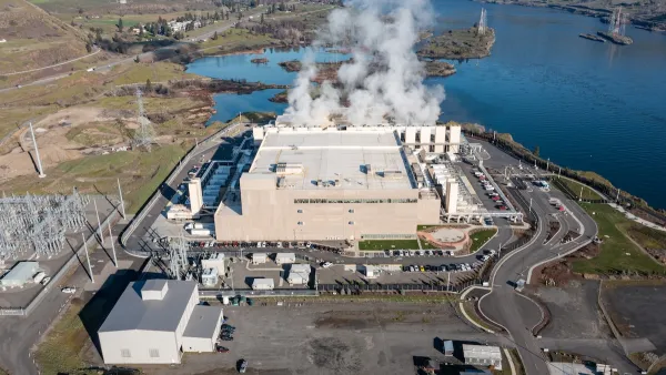 Aerial drone picture of a massive hyperscale Google data center campus with cooling steam rising from industrial cooling systems, located along the Columbia River.