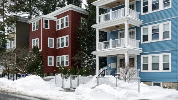 BLue and red triple-story homes in Boston, Massachusetts.