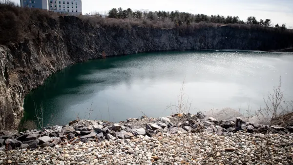 A quarry in Maine, filled with water and surrounded by stones.