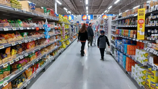 People walking down aisle of grocery store in Toronto, Canada.