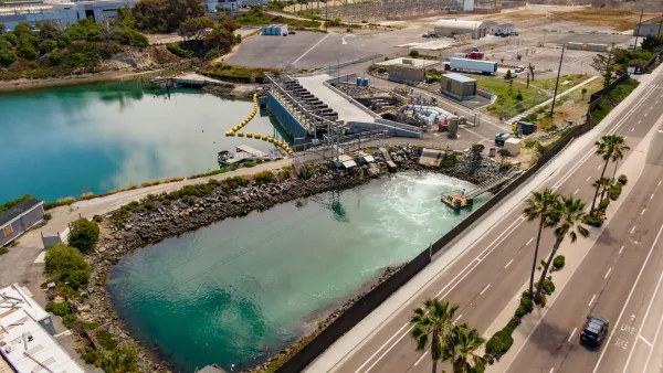 Aerial view of turquoise water holding tanks in desalination plant in San Diego, California.