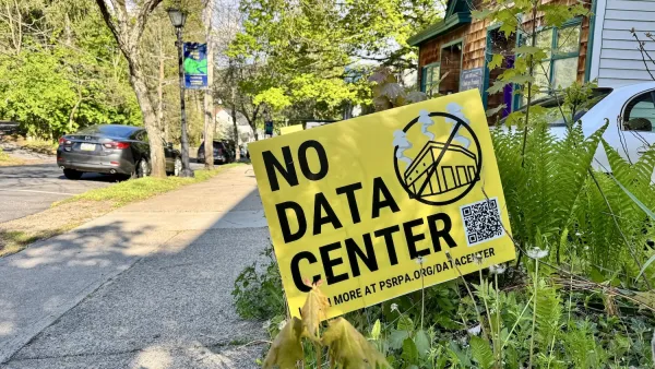 A yellow yard sign with "NO DATA CENTER" in black text.