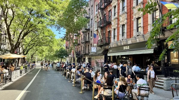 People drinking at outdoor tables in front of Bua bar on the Open Street, a car-free pedestrian zone, on St. Mark's Place in the East Village, Manhattan, New York City