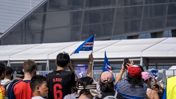 Crowd of soccer fans outside Atlanta stadium celebrating 2026 World Cup.