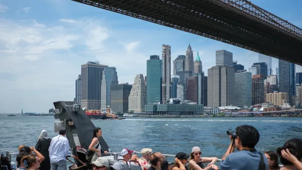 A group of people on a ferry in NYC, with the harbor and skyline visible.