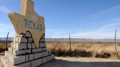 Texas-shaped road sign with TEXAS text on rural roadside