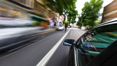 Blurry speeding cars on an urban road