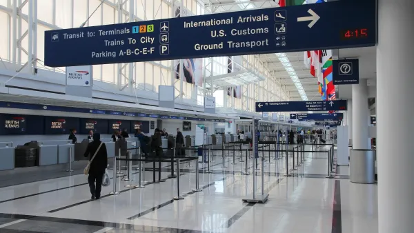British Airways ticketing booths in mostly empty hall at Chicago airport.