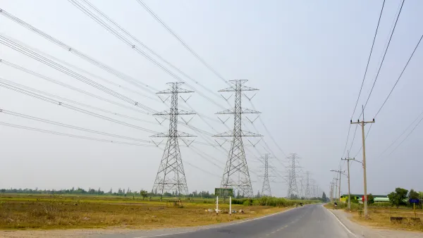 High voltage transmission lines alongside a road.