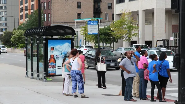 People waiting at a Chicago bus stop.