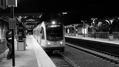 Black and white photo of Los Angeles Metro Gold Line train pulling into above-ground station at night, with one woman passenger waiting on platform.