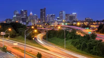 Nighttime view of downtown Columbus, Ohio over freeways with fast-moving traffic