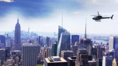 Helicopter flying over New York City with Empire State Building visible on left