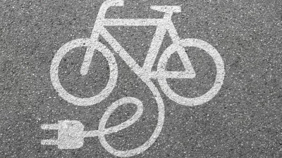 White electric bike logo on asphalt
