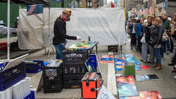 Artist painting live as people watch on New York City sidewalk.