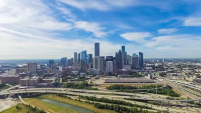 Serial view of elevated freeway interchanges with downtown Houston in background