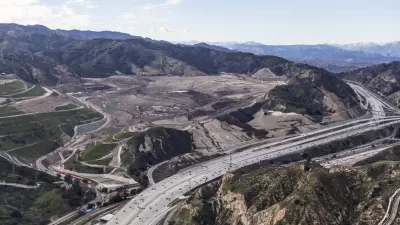 Aerial view of I-5 freeway and large landfill in hilly part of Los Angeles County