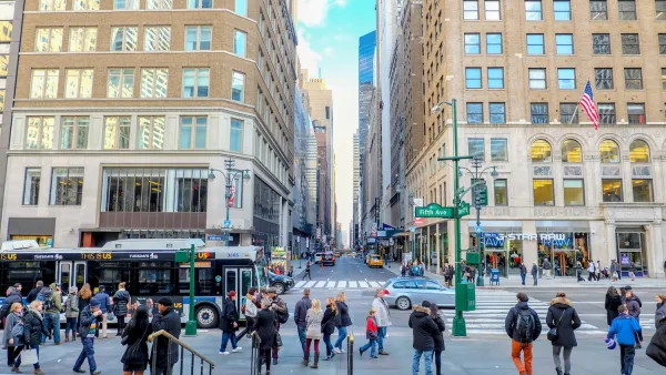 People at a busy New York City intersection crosswalk.