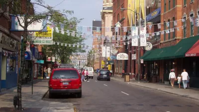 Two-lane street in Detroit's Greektown with American and Greek flags strung across the street
